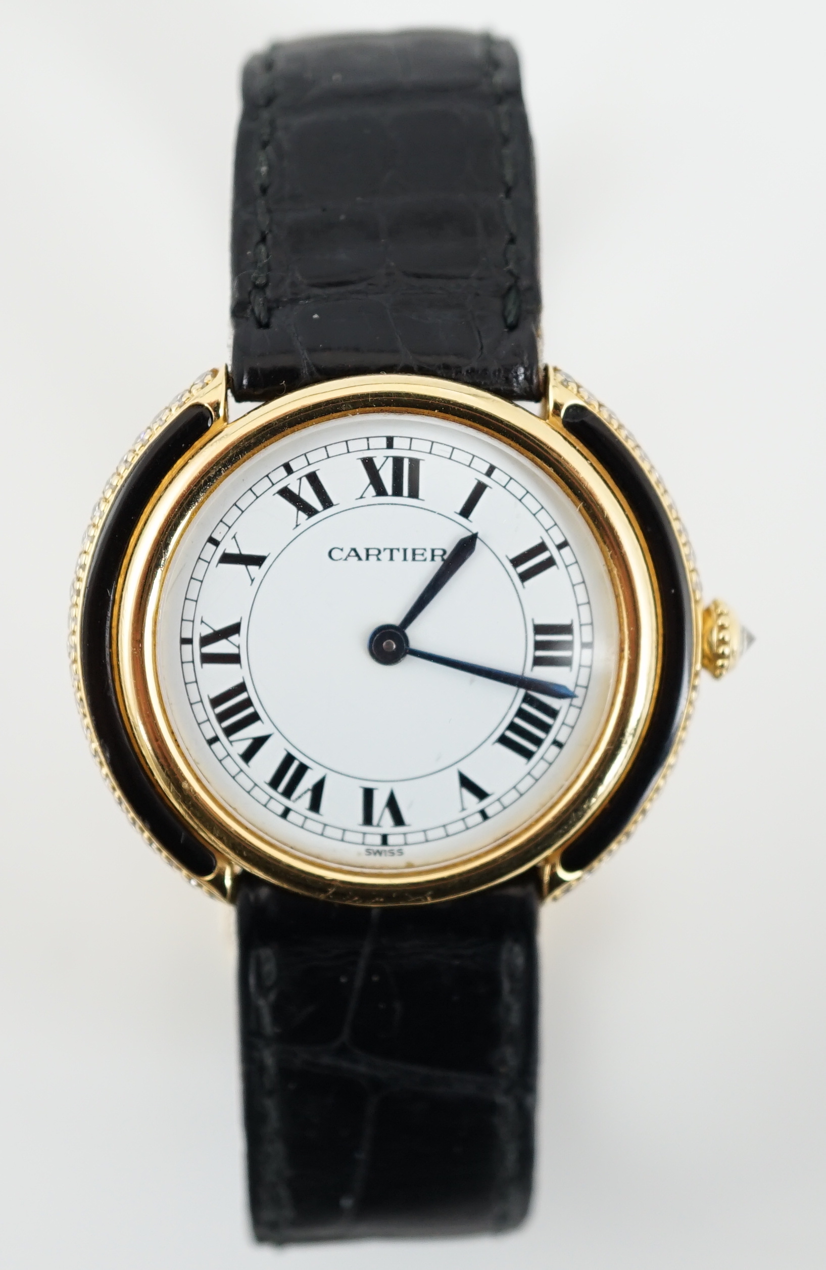 A lady's 18ct gold, black onyx and diamond set Cartier Vendome manual wind wrist watch